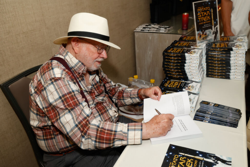 Chester L Richard signs books